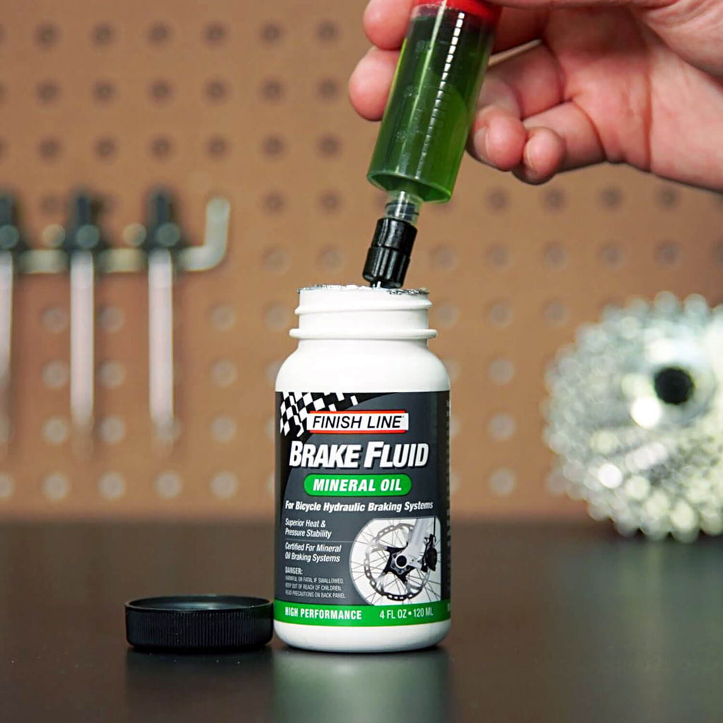 finish-line-mineral-oil-brake-fluid-120ml-4floz-green-syringe-from-bottle-lifestyle