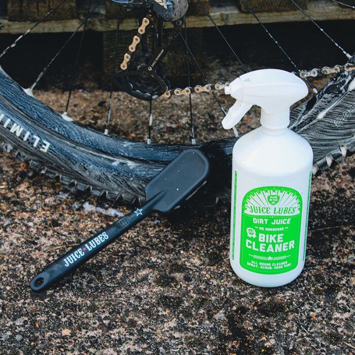 Juice Lubes Dirt Daddy - Tyre & Cassette Brush shown with a bottle of Juice Lubes Bike Cleaner